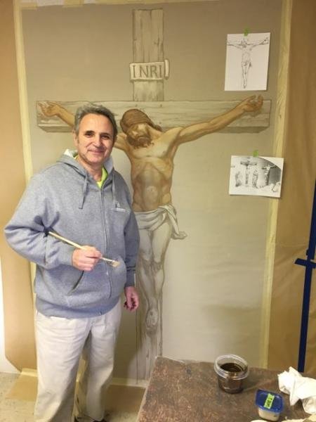 From a temporary studio in Westphalia, artist Stoyko Stoykov of Conrad Schmitt Studios works on a mural depicting the Crucifixion for the area high above the altar in historical St. Joseph Church. The artwork is part of a comprehensive renovation of the church’s exterior and interior.
