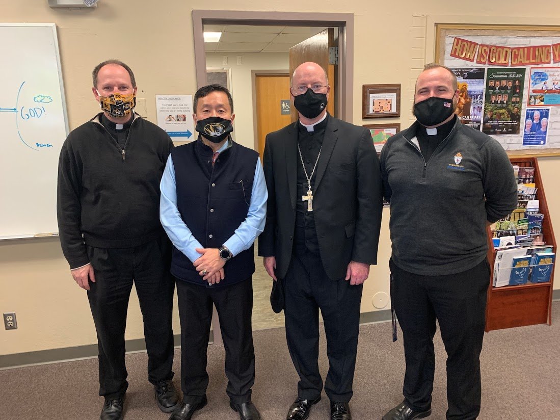 Father Daniel Merz, pastor of St. Thomas More Newman Center parish in Columbia; Dr. Mun Choi, president of the University of Missouri and chancellor of its Columbia campus; Bishop W. Shawn McKnight; and Father Paul Clark, associate pastor, pause for a photo during Dr. Choi’s visit to the Newman Center.