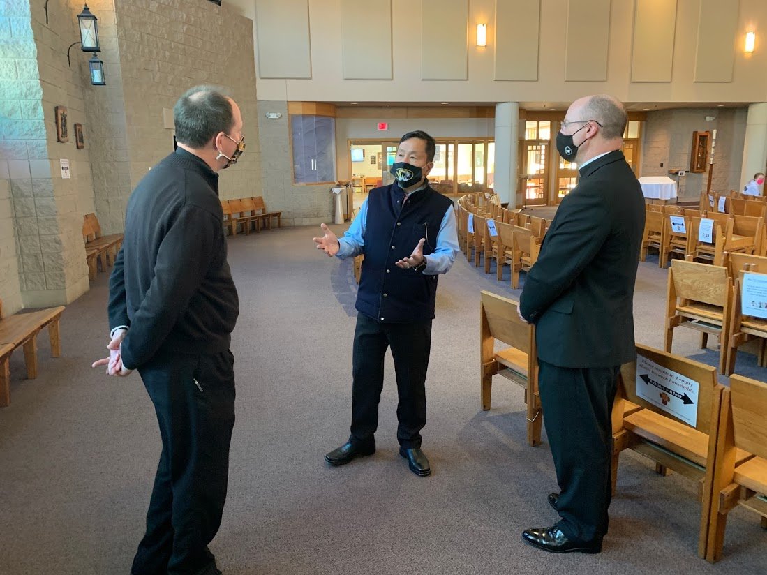 Dr. Mun Choi, president of the four-campus University of Missouri system and chancellor of the flagship Columbia campus, visits with Father Daniel Merz, pastor of St. Thomas More Newman Center, and Bishop W. Shawn McKnight in the Newman Center Chapel.