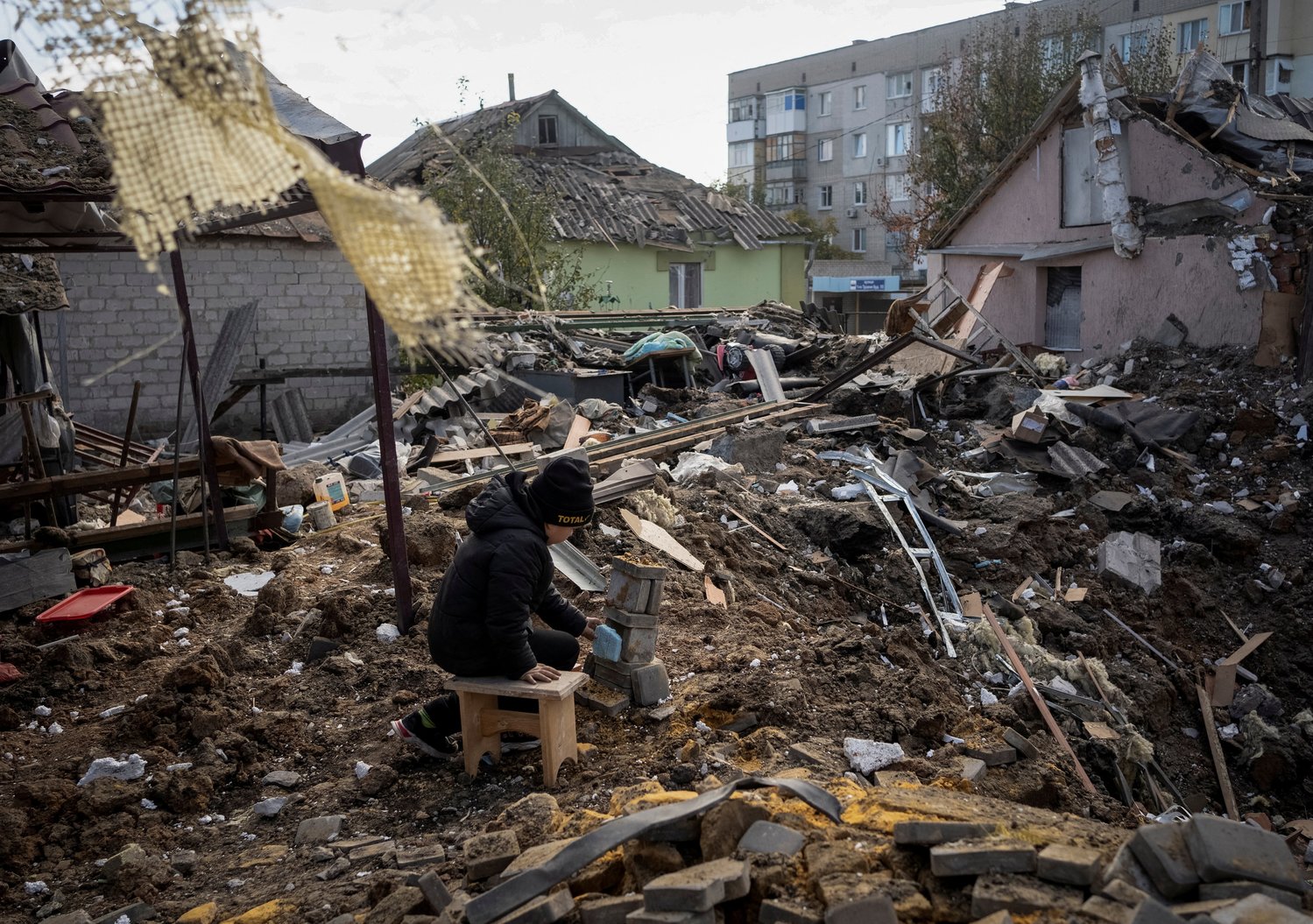 A boy plays on the ruins of his grandmother's house in Kupiansk, Ukraine, Oct. 16, 2022, amid Russia's attack on Ukraine. During the month of November, Pope Francis is asking people to pray for children who are suffering because of poverty, war and exploitation.