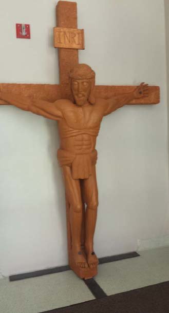 This carved wooden crucifix that adorns the student entrance to the St. Thomas More Newman Center in Columbia was made by Deacon Fred Weisel.