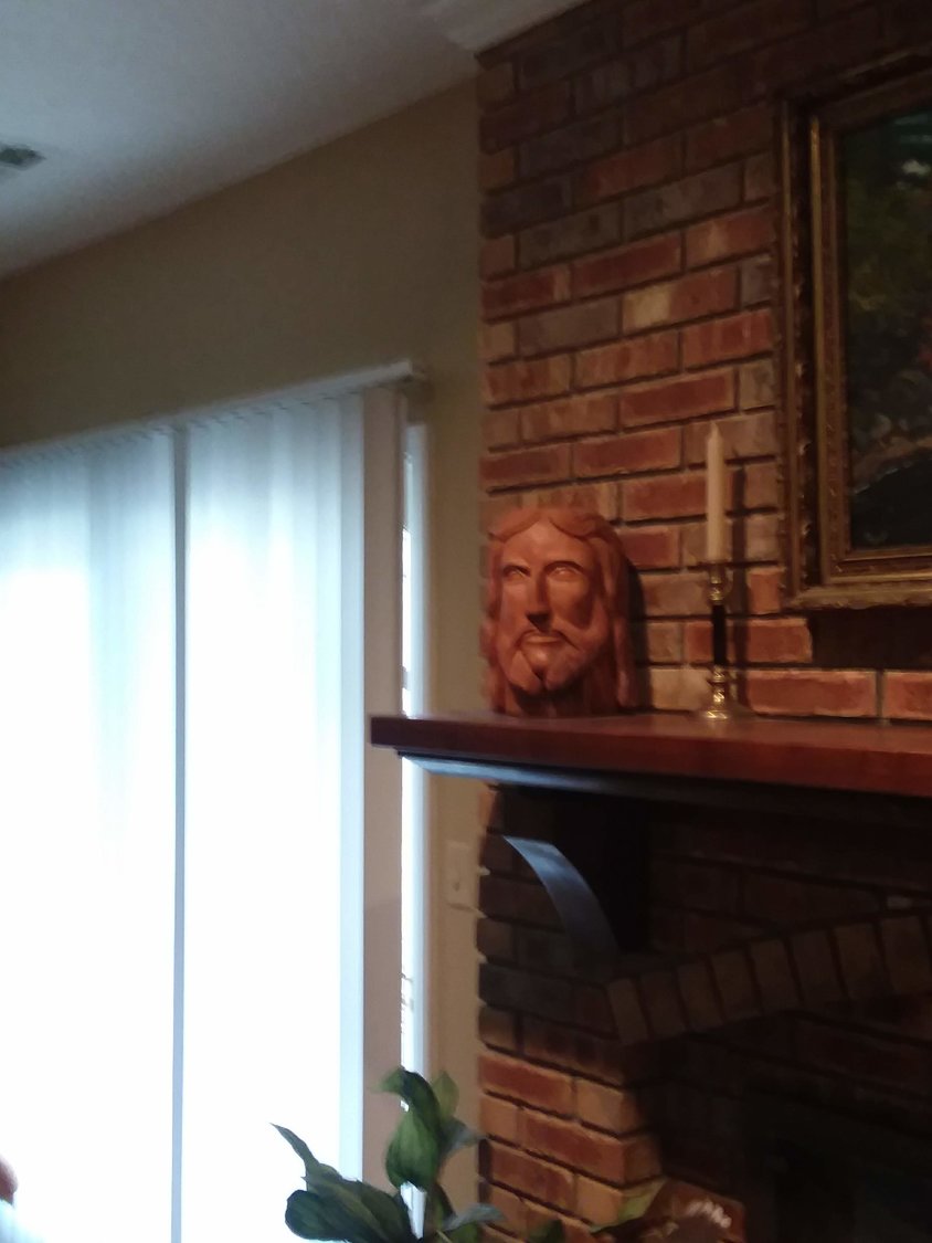 Deacon Fred Weisel carved this image of Jesus' head on his mentle.